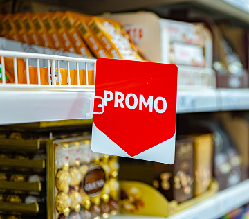 grocery store aisle and close up of a 'Promo' shelf sign