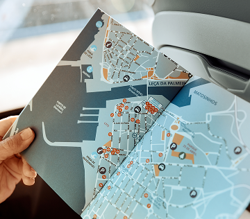 personal holding open a map of a city