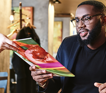 man at restaurant being handed a menu