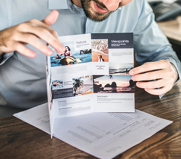 man presenting a trifold manual